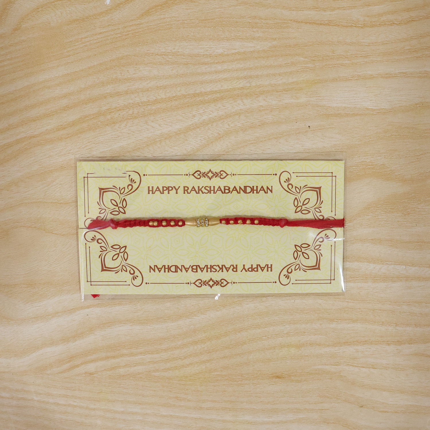 Minimal Red Thread Rakhi with Small Golden Bead Pendant Accents
