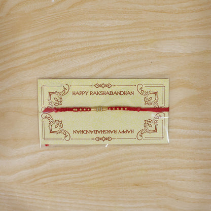 Minimal Red Thread Rakhi with Small Golden Bead Pendant Accents