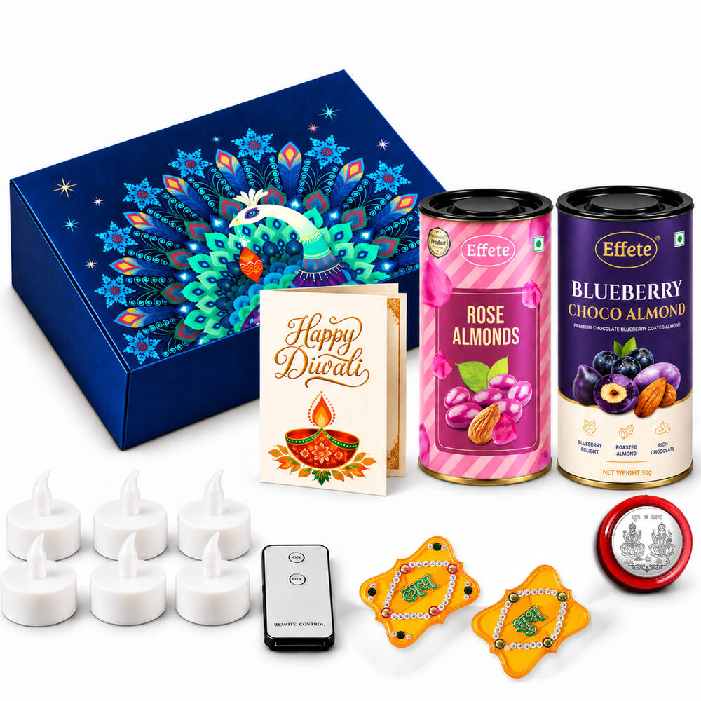 A blue peacock-themed box, two tins of flavored almonds, a Diwali card, LED tealights, remote, and Shubh-Labh decor.