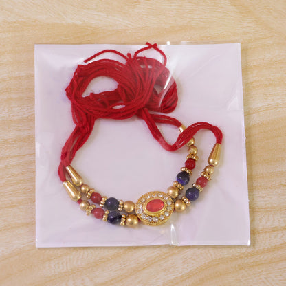 Red Blue Beaded Rakhi with Ruby Center and Rich Traditional Festive Gift Styling