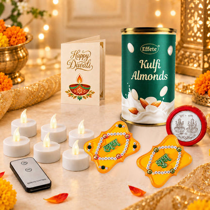 A can of Kulfi almonds, a Diwali card, six white LED tealights, a remote, and two yellow Shubh Labh decorations on a table