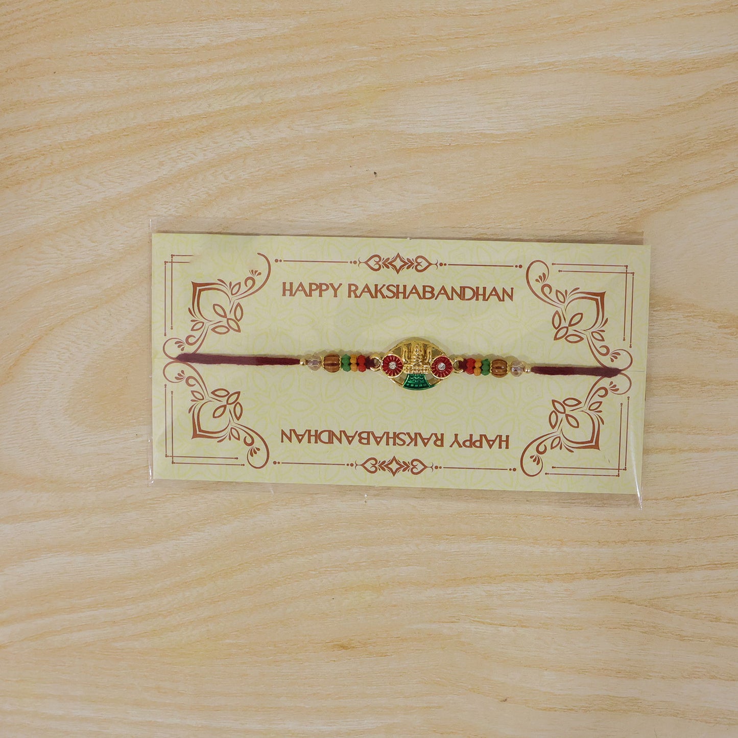 Golden Kalash Temple Devotional Rakhi with Red Green Details and Festive Beads