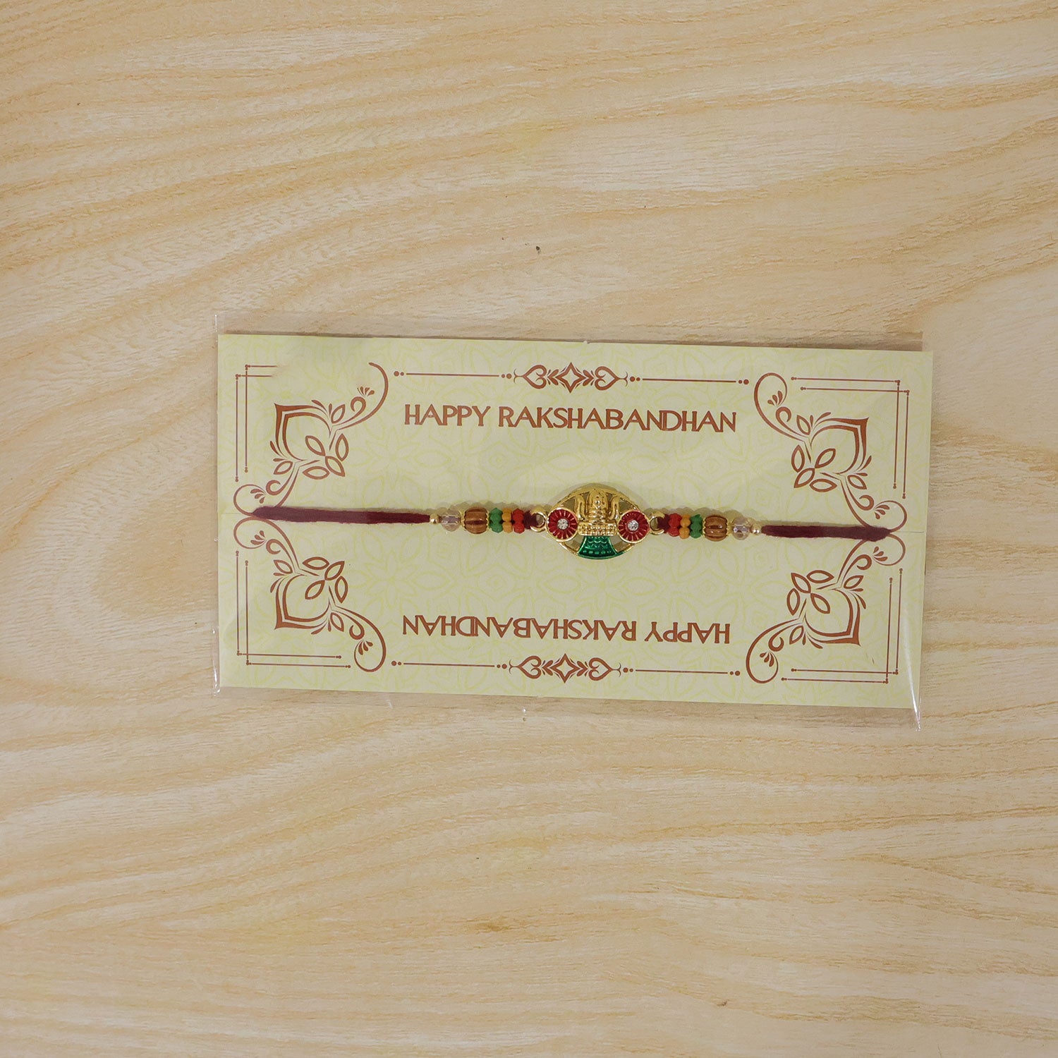 Golden Kalash Temple Devotional Rakhi with Red Green Details and Festive Beads