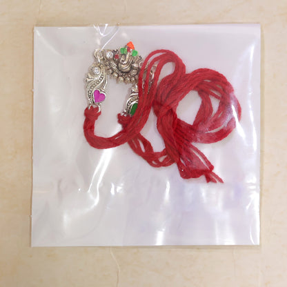 Silver-Toned Lord Ganesha Rakhi with Floral Design, Crystal Accents & Designer Red Thread