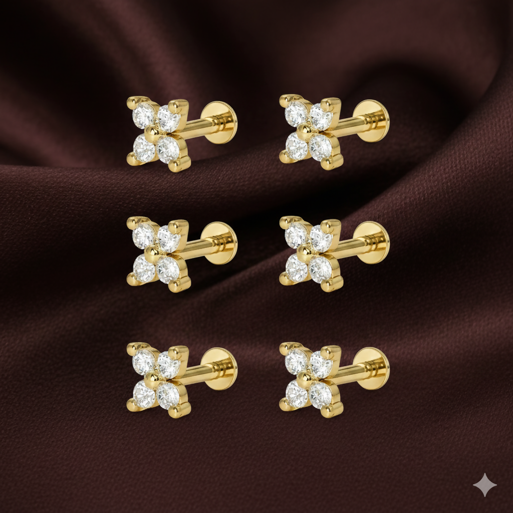 Close-up of gold plated flower stud earrings showcasing ruby center and sparkling halo