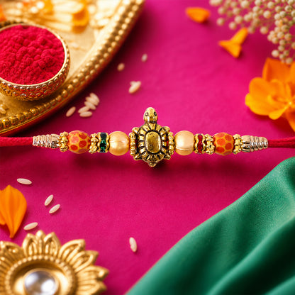 Red Thread Rakhi with Antique Gold Turtle Pendant and Beaded Accents