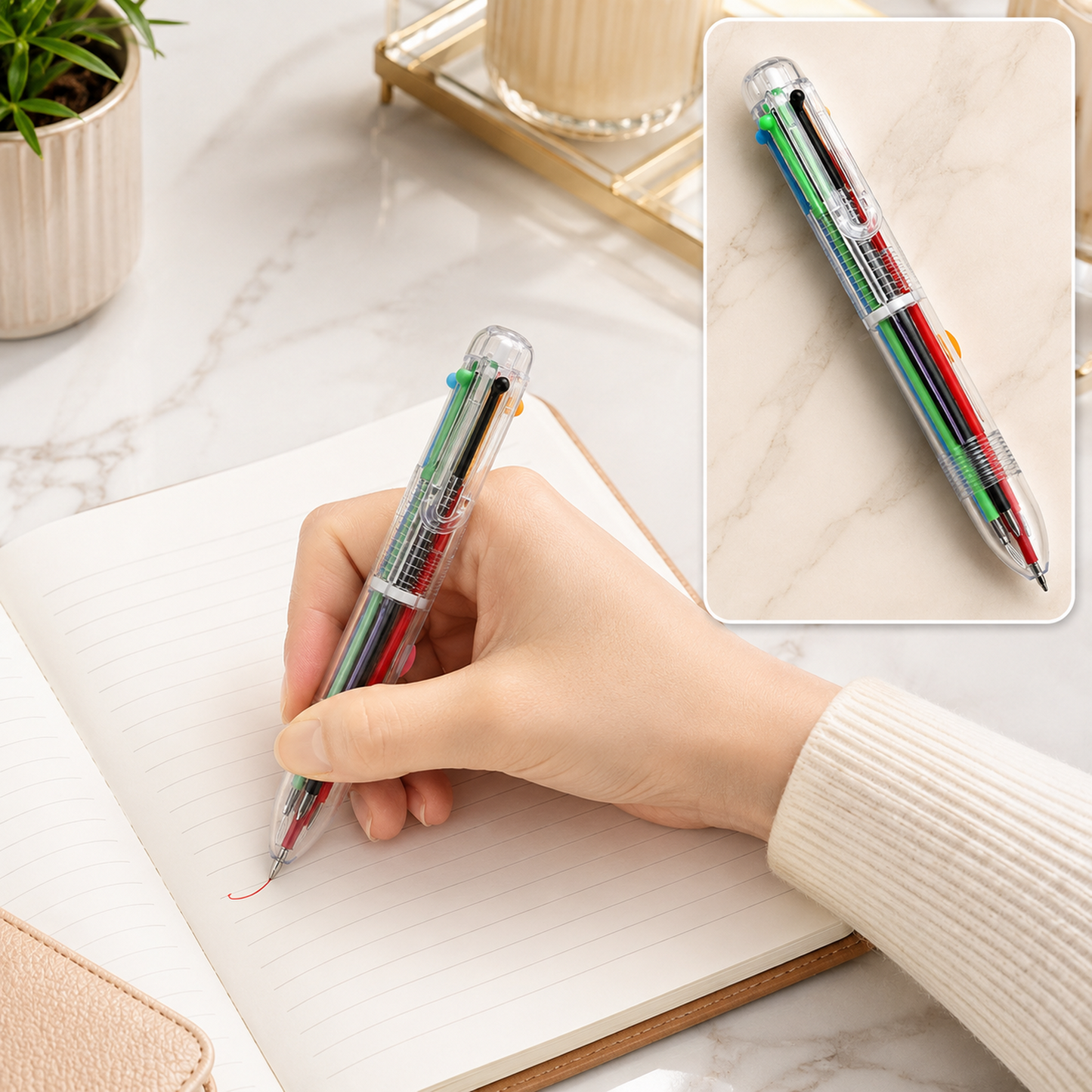 A hand holds a clear 6-in-1 multicolor ballpoint pen, writing in a notebook, with a close-up inset of the pen.