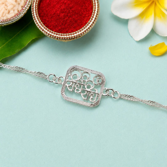 Silver Radhe Radhe Rakhi displayed with intricate craftsmanship, ideal for Rakshabandhan.