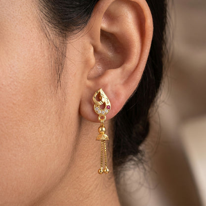 Side view of traditional leaf-inspired gold earrings with cascading bead chains