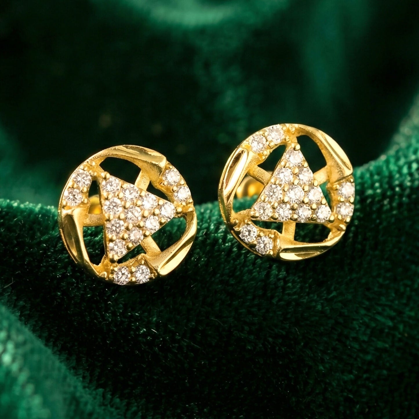 Sparkling gold stud earrings crafted with intricate design and stone accents