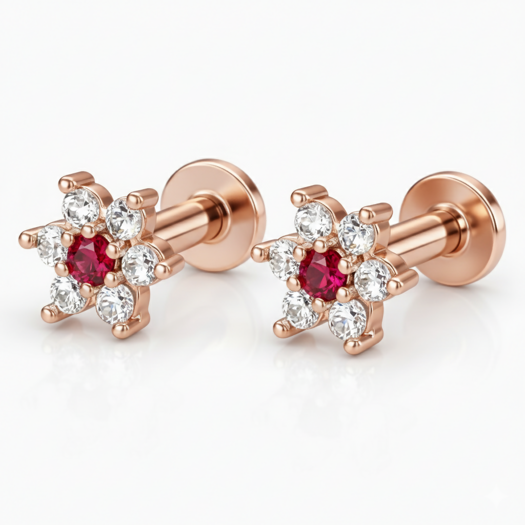 Top view of rose gold floral earrings with ruby and diamond details