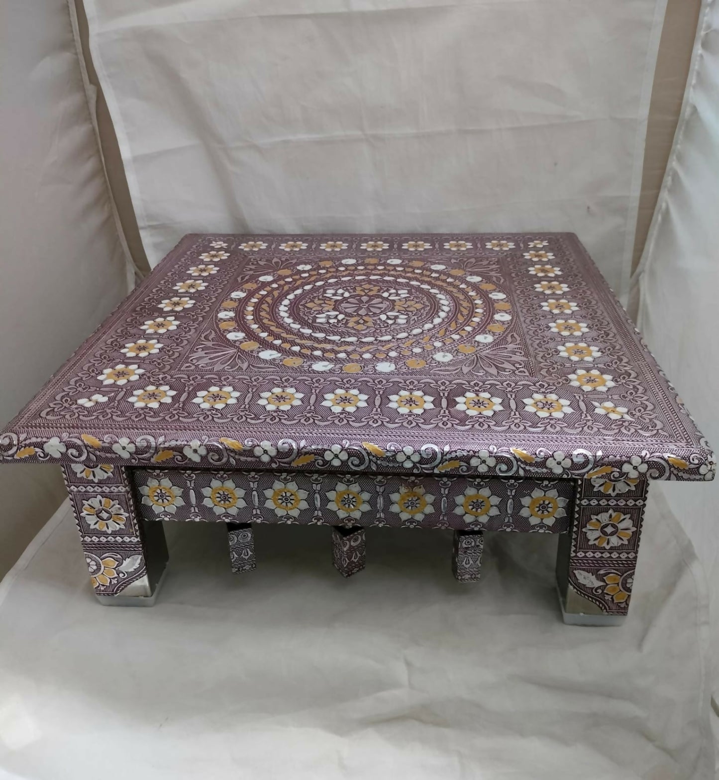 Stylized shot of the Rajwadi oxidised Pooja Chowki, highlighting its golden finish.