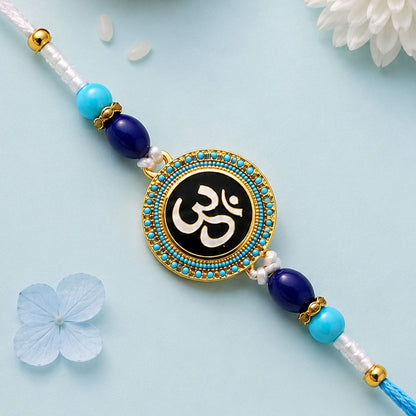 Round Om Stone Studded Enamel Rakhi with Cute Doll Keychain Combo (2 Pc)