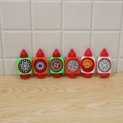 Six colorful rangoli powder bottles with decorative labels and stamping bases, standing upright on a light wooden surface