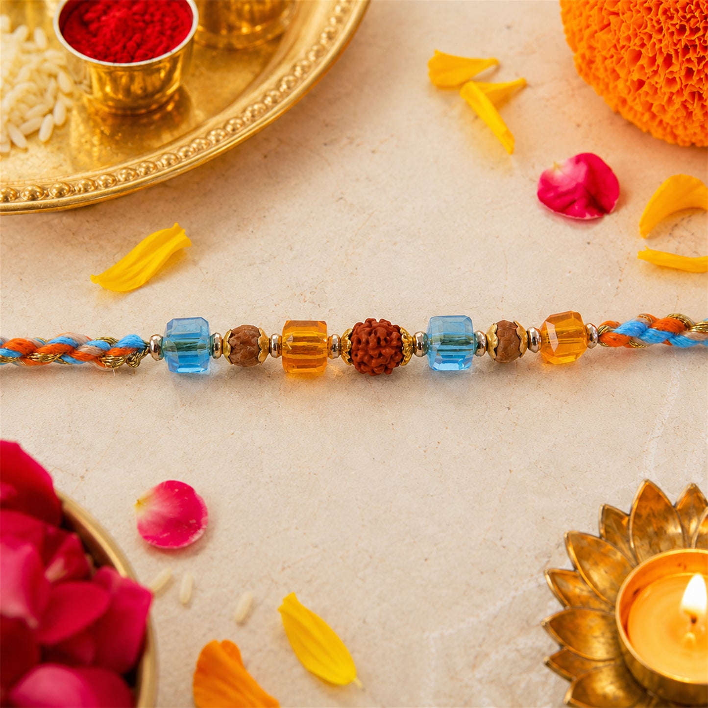 Blue Beaded Bracelet Rakhi with Golden Spacers and Colorful Festive Charm