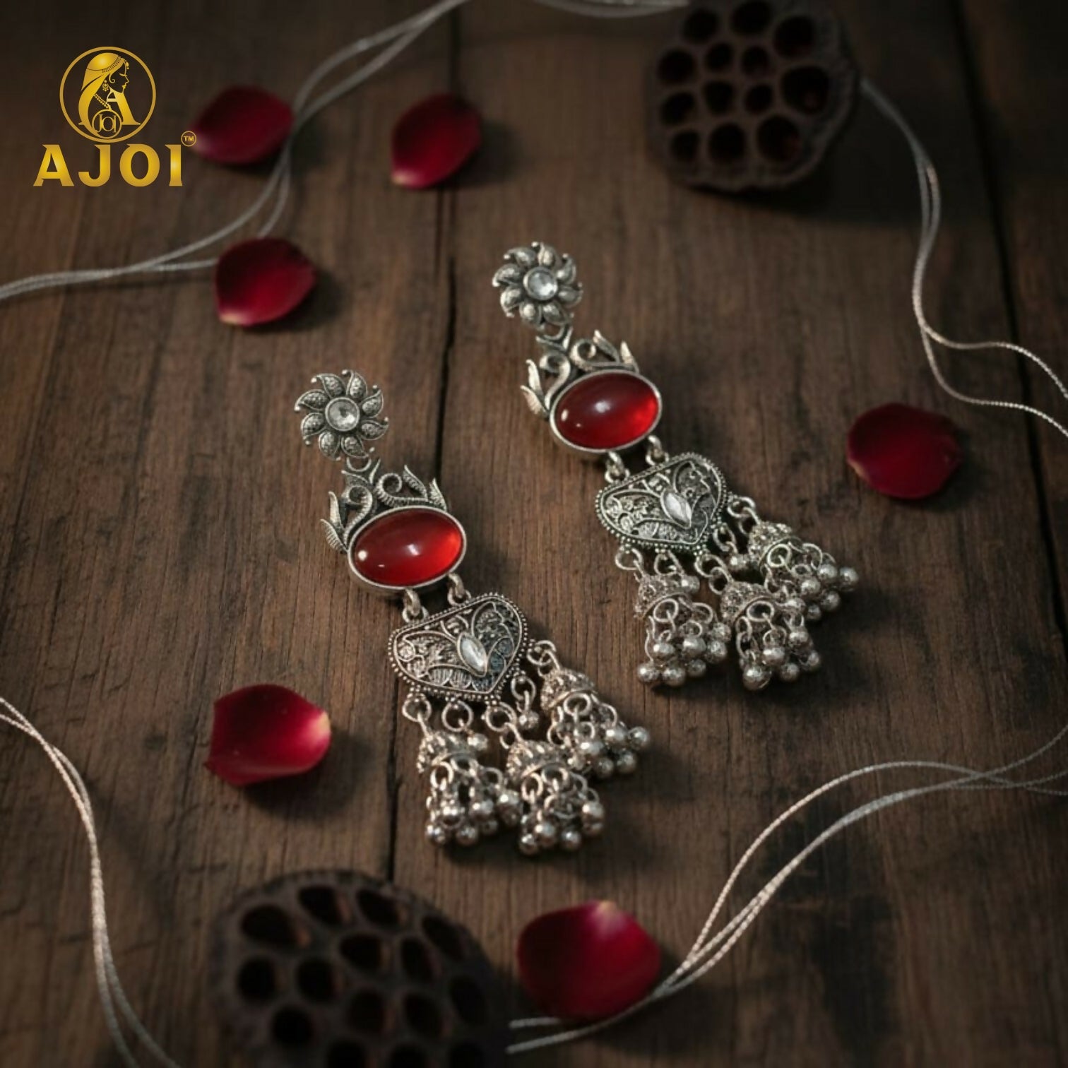 Vintage-Inspired Oxidized Silver Red Stone Jhumka Earrings with Ornate Filigree Design and Cascading Bell Danglers