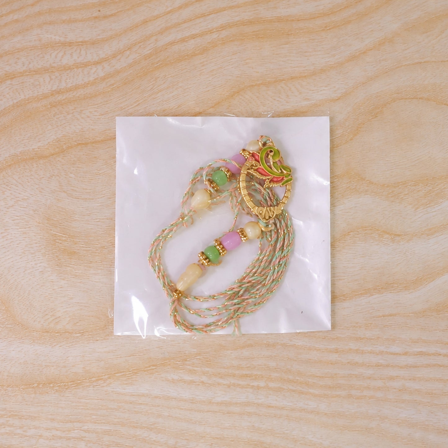 Enamel Peacock Pendant Rakhi with Green and Orange Beads