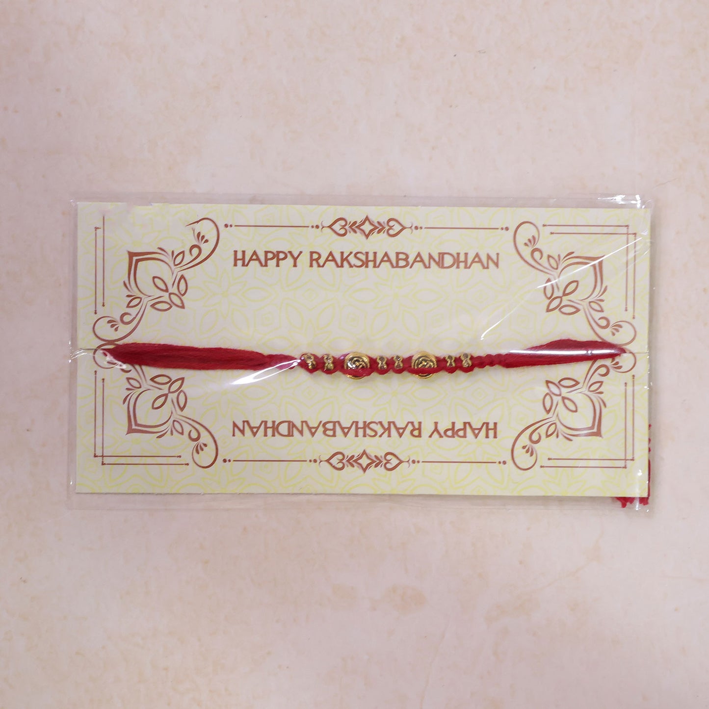 Red Braided Rakhi with a Row of Antique Gold Coin-Style Charms