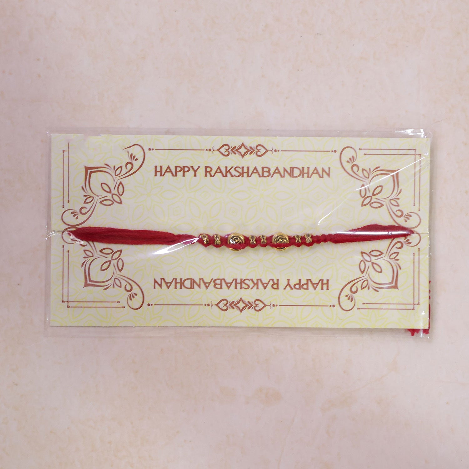 Red Braided Rakhi with a Row of Antique Gold Coin-Style Charms