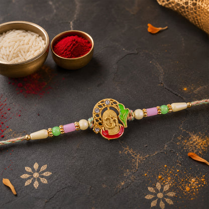 Textured Gold Om Pendant Rakhi with Leaf Accent and Pearl Beads