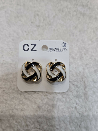 Two black and white enamel knot stud earrings are attached to a white CZ Jewellery card.