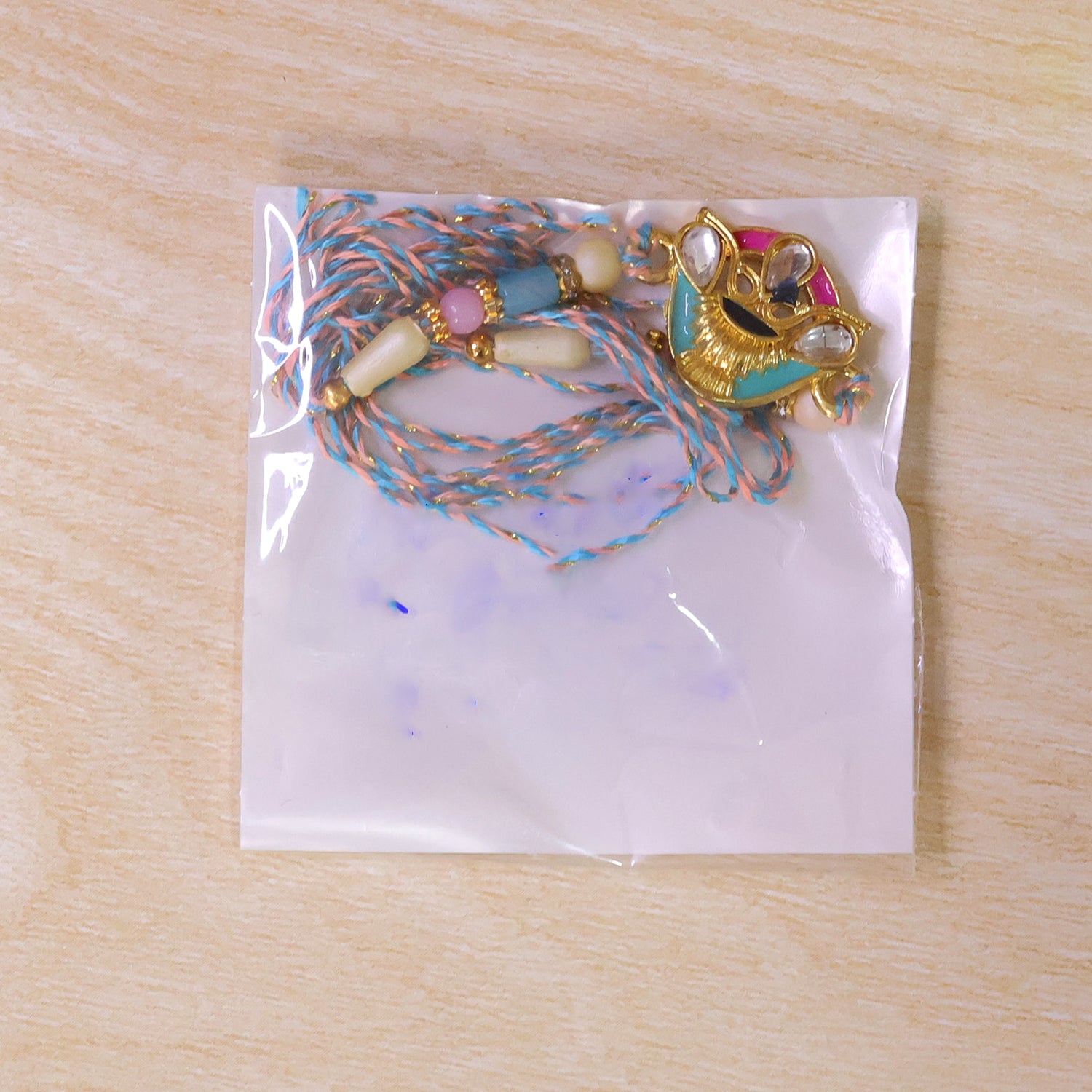 Crown Shaped Kundan Pendant Rakhi with Pink and Teal Enamel