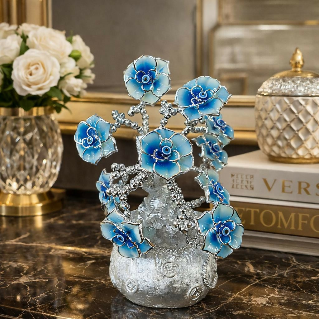 Close-up of silver flower tree showing delicate pearl-like flowers and blue evil eye symbols