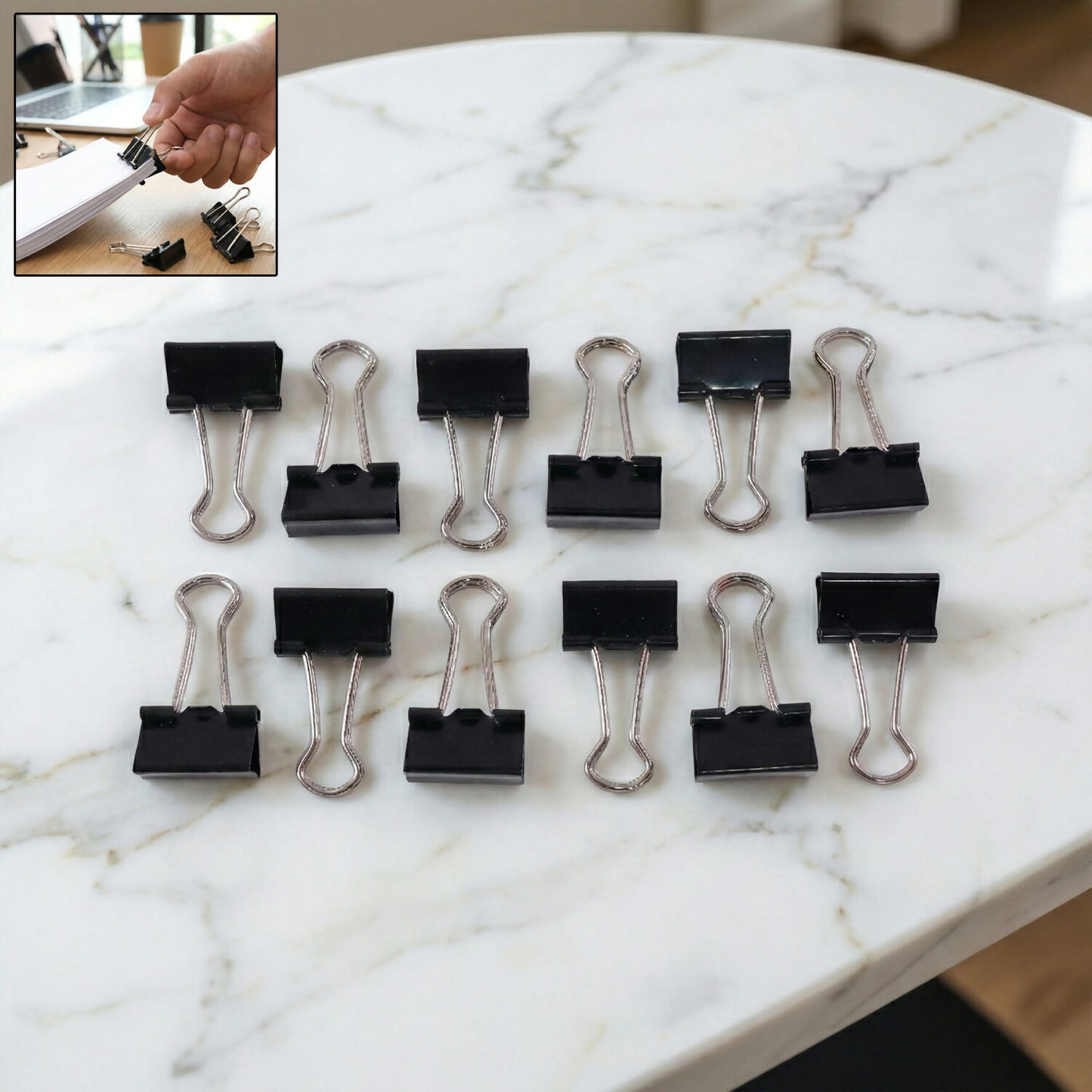 Stack of documents secured with black binder clip