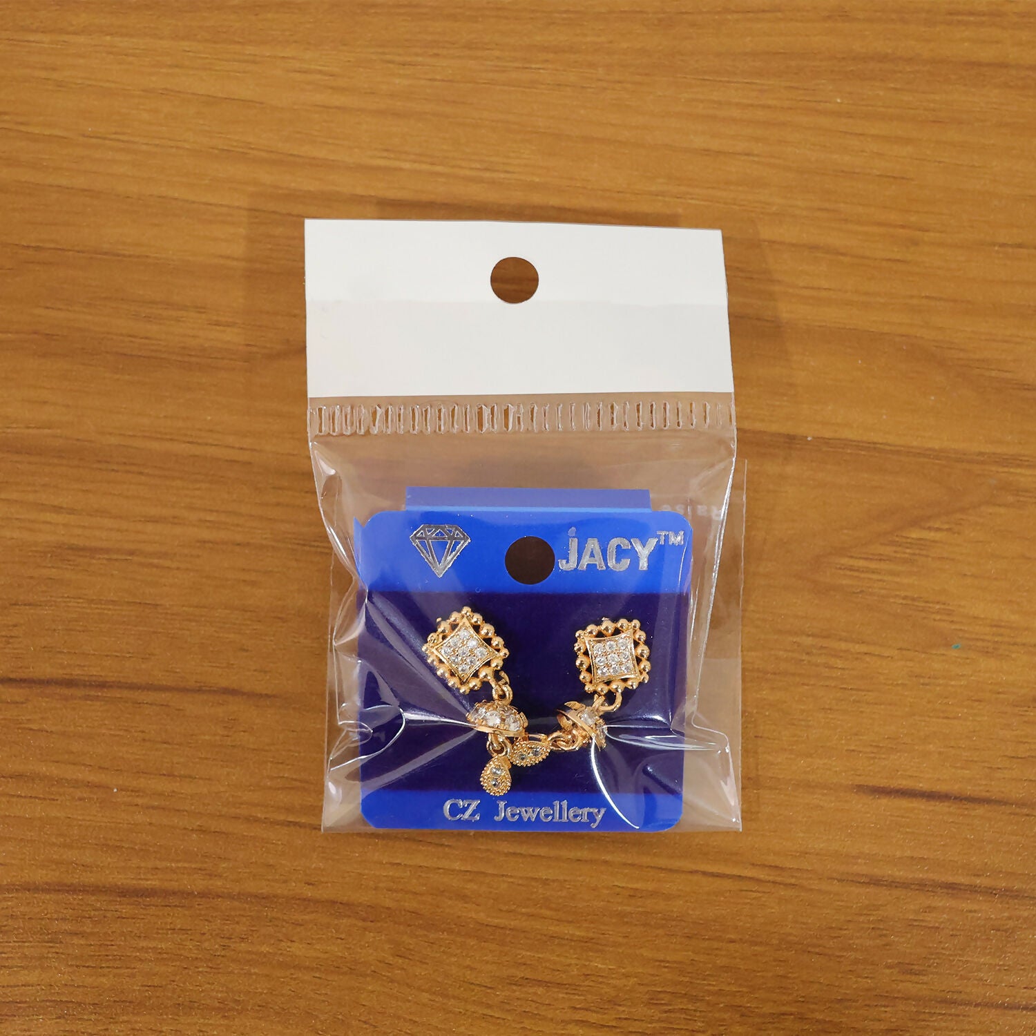 Front view of lightweight gold Jhumka drop earrings with sparkling crystal details