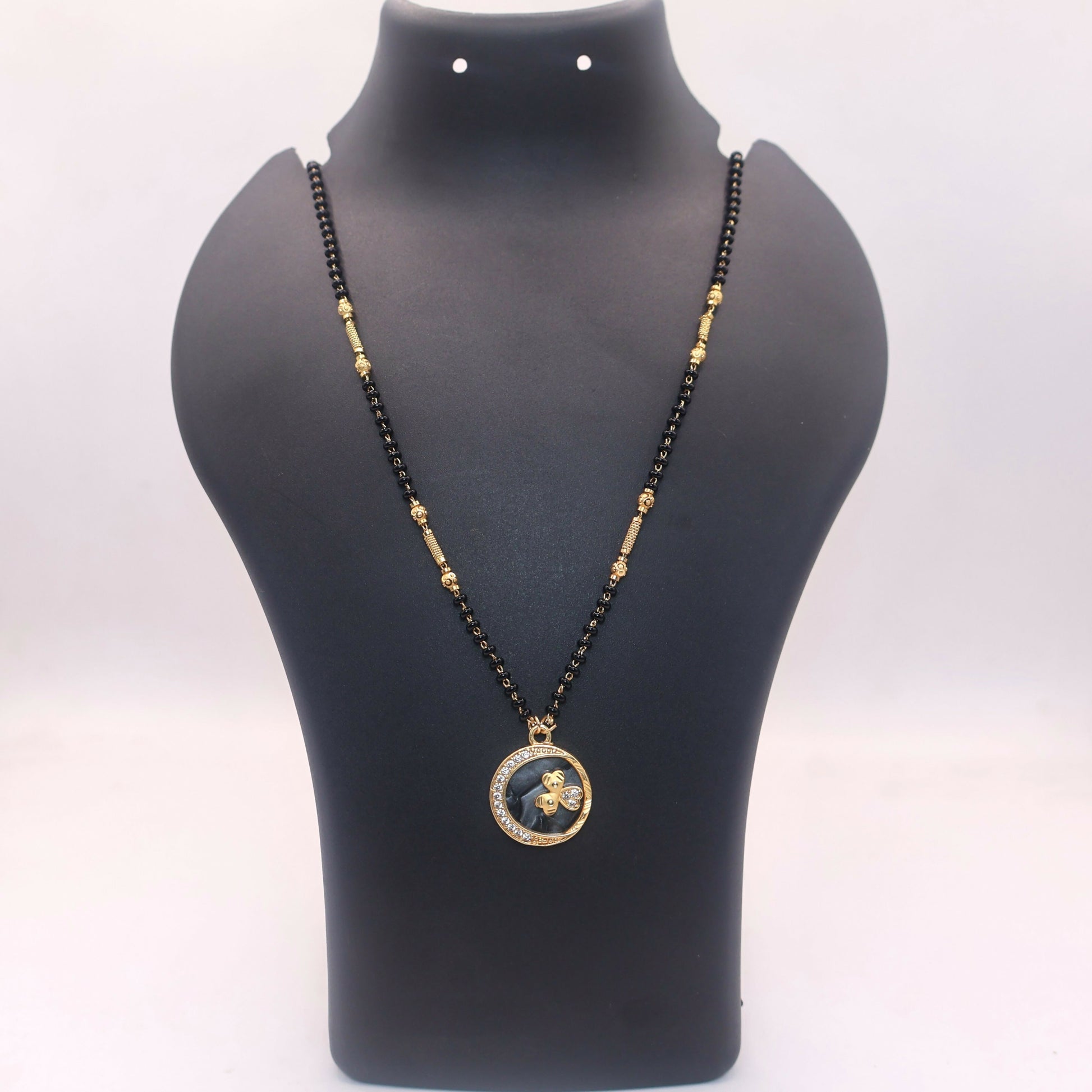 Black beads chain with gold spacers in butterfly coin pendant mangal sutra