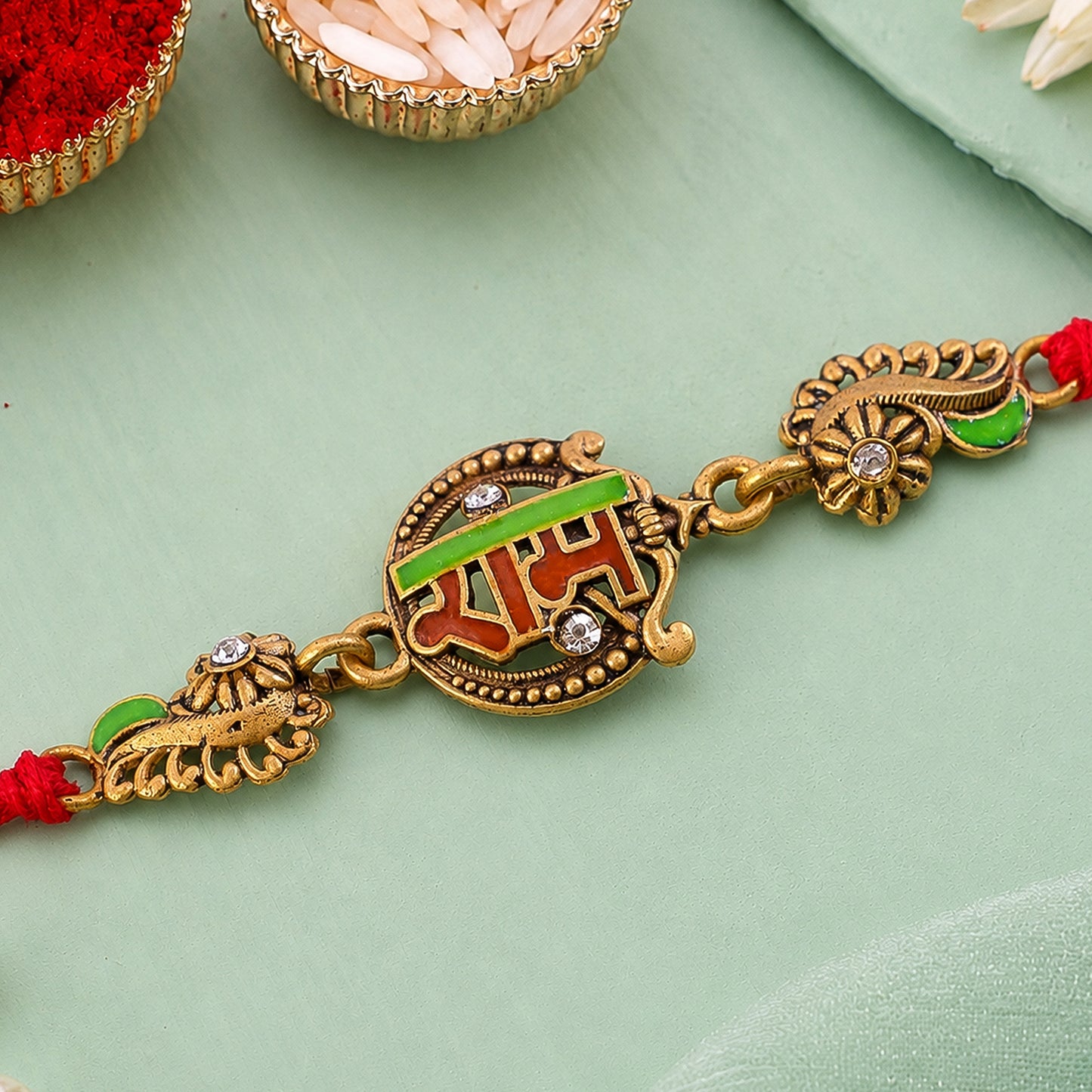 Antique Gold-Toned Ram Rakhi with Crystal Accents, Green Enamel & Designer Red Thread