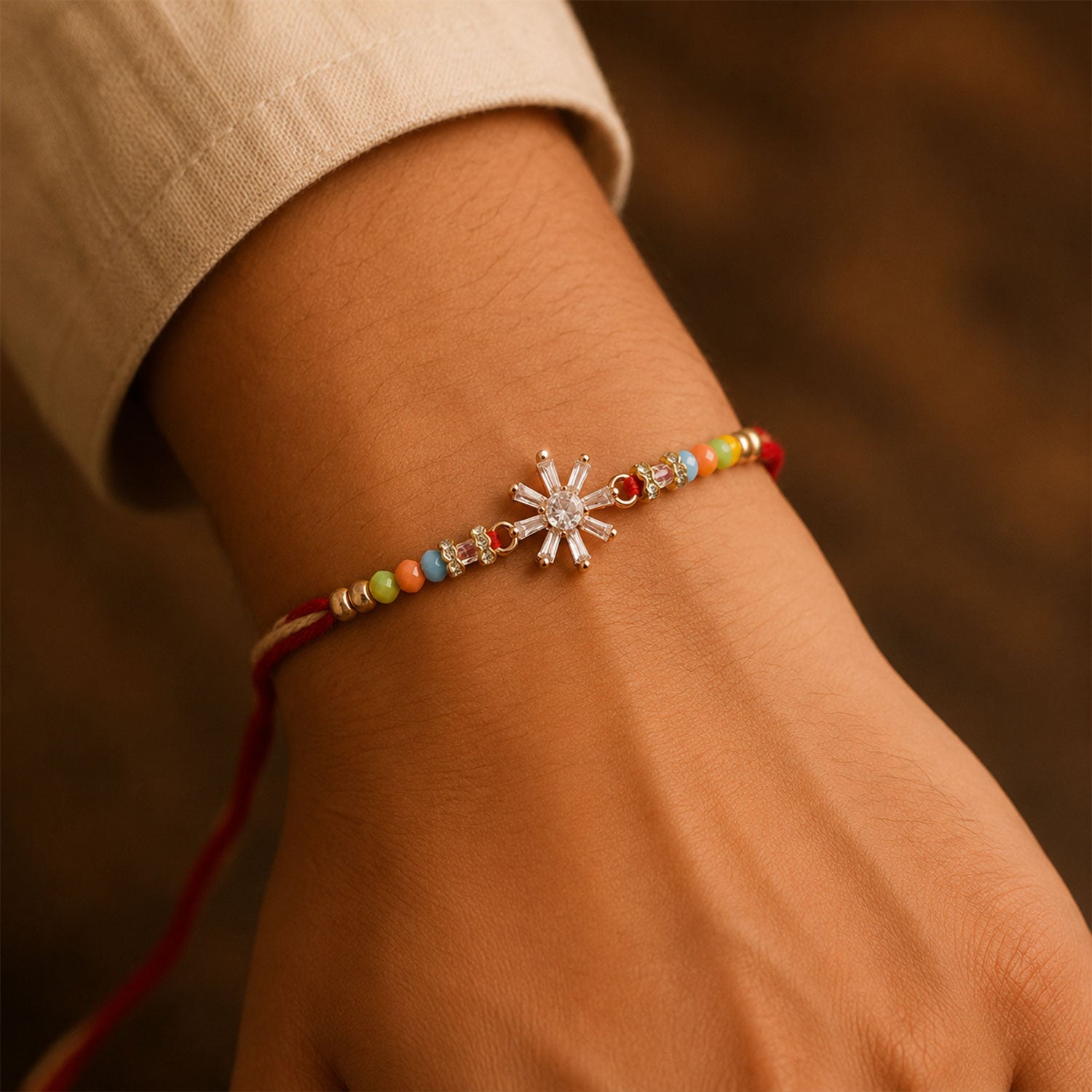 Rose Gold Sunburst Crystal Rakhi with Rainbow Beads, Roli Chawal Coin and Festive Gift Packing