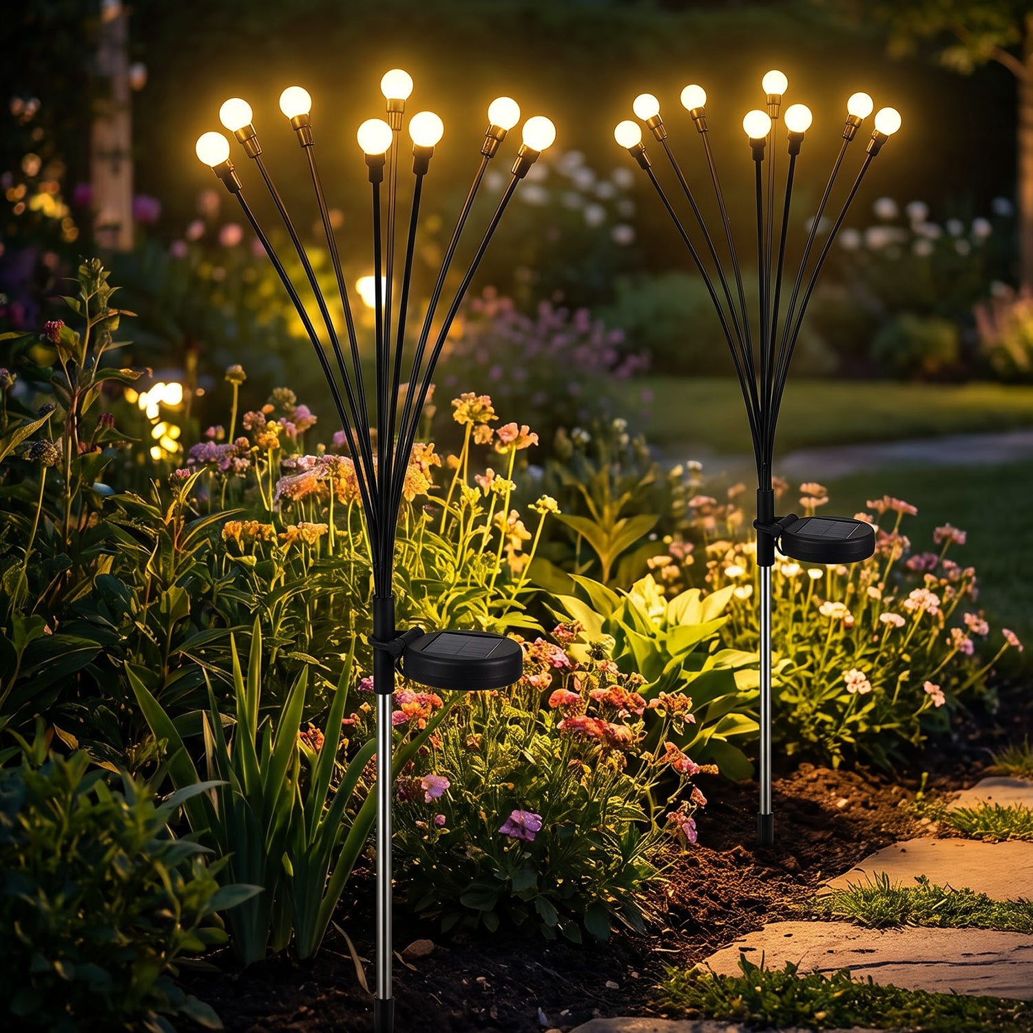 Solar firefly garden stake lights illuminating flower beds