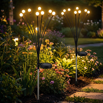 Solar firefly garden stake lights illuminating flower beds