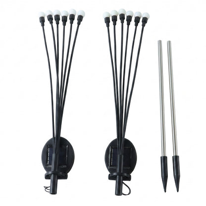 Two solar garden lights with stakes on white background
