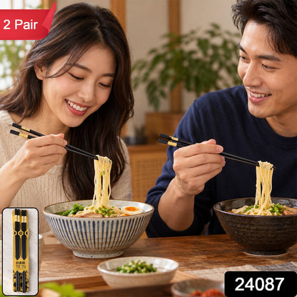 A smiling couple eats noodles with black and gold chopsticks, with a '2 Pair' label and product code overlay.