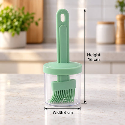 The light green silicone basting brush is stored inside its clear container with a matching green lid, showing height and