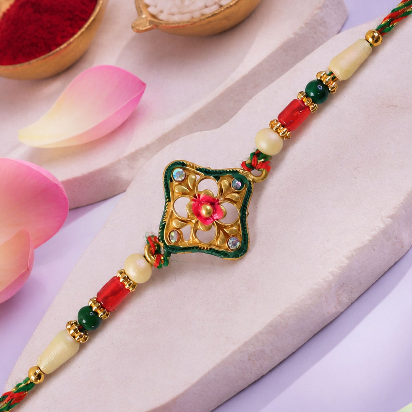Green Enamel Kite Shaped Pendant Rakhi with Red Flower Center