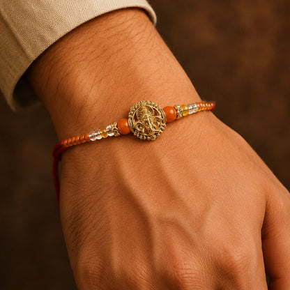 Lord Ganesha Golden Devotional Rakhi with Orange Beads and Crystal Highlights