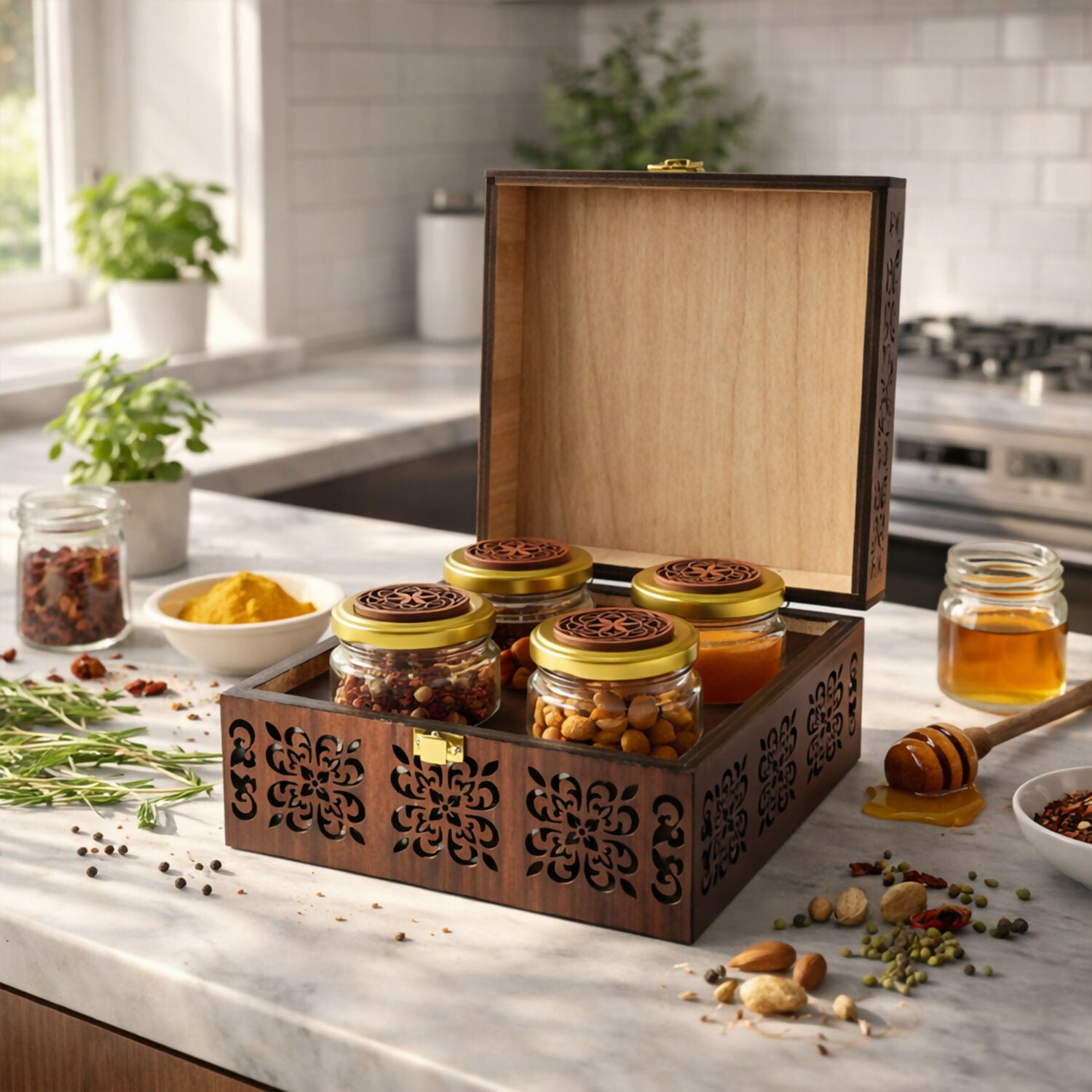 Opened wooden storage box displaying four glass jars with gold lids inside the hand-carved chest
