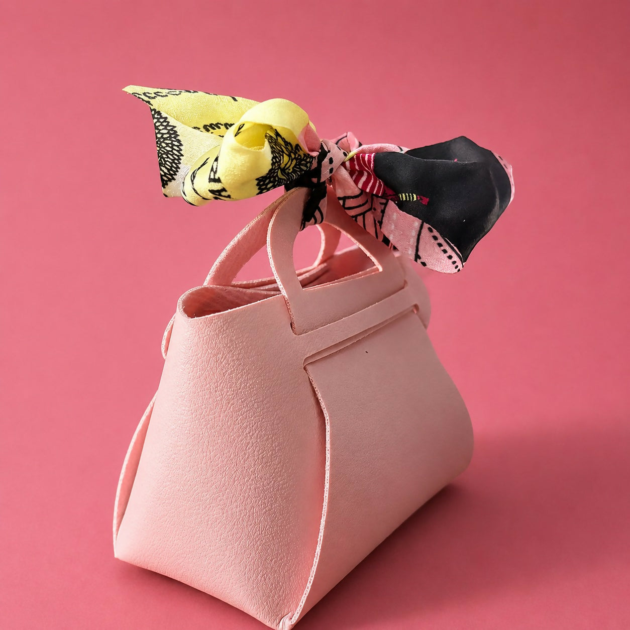 Front view of pink mini handbag with ribbon detail