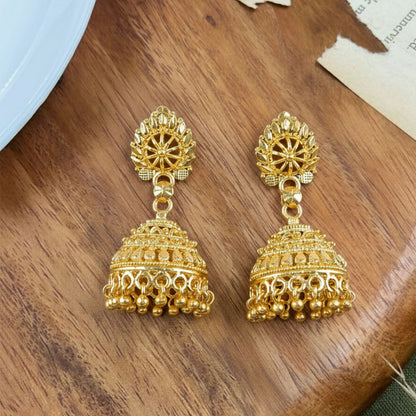 Side view of traditional gold plated jhumka earrings with beads detailed