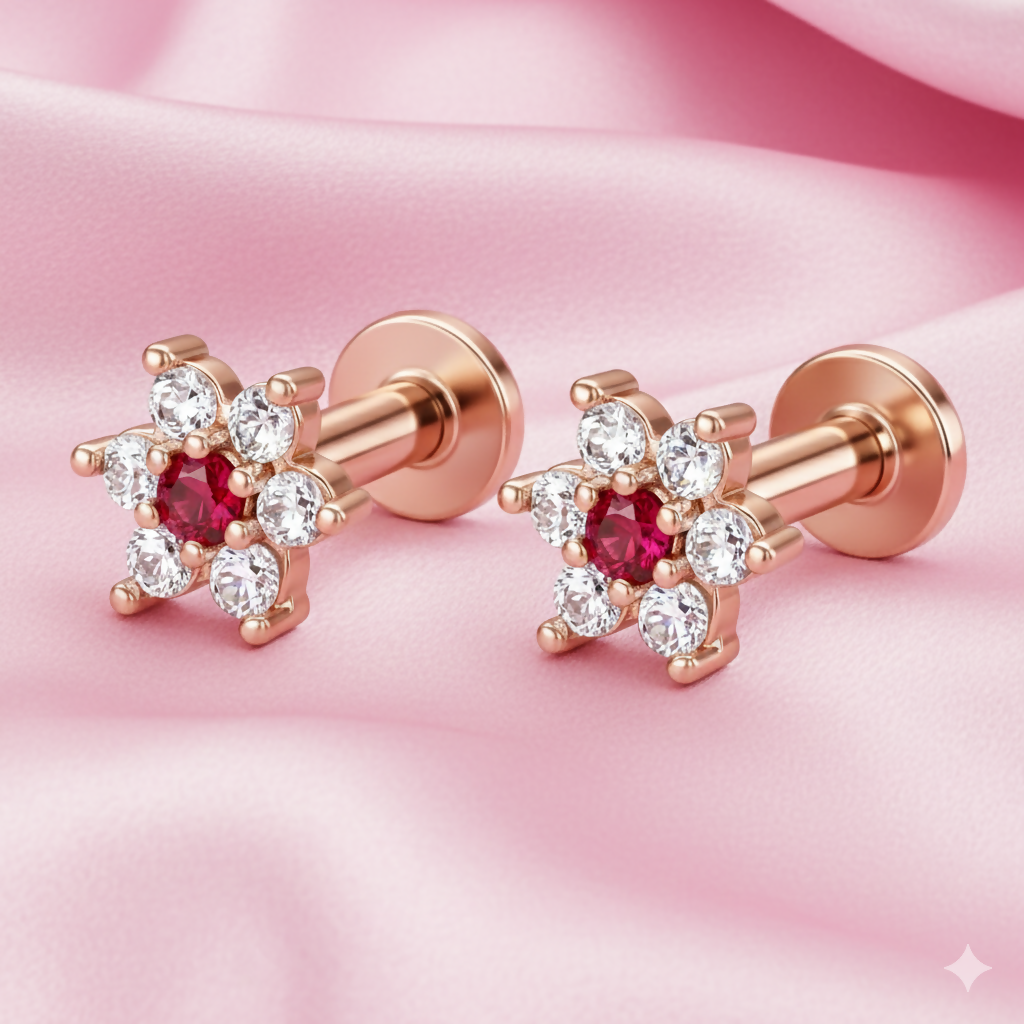 Close-up of ruby red flower nosepin stud highlighting rose gold finish and crystals