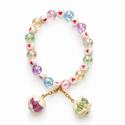 The multicolor beaded bracelet with heart details and two flower charms, isolated against a white background.