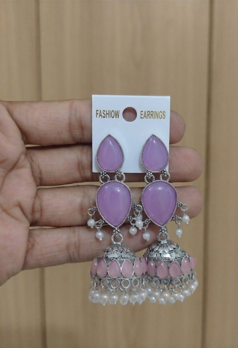 Oxidized silver Jhumka earrings with deep purple stones front view