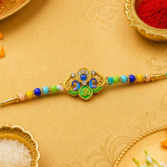 A colorful beaded bracelet with a gold and enamel centerpiece featuring an Om symbol rests on a yellow surface with ritual