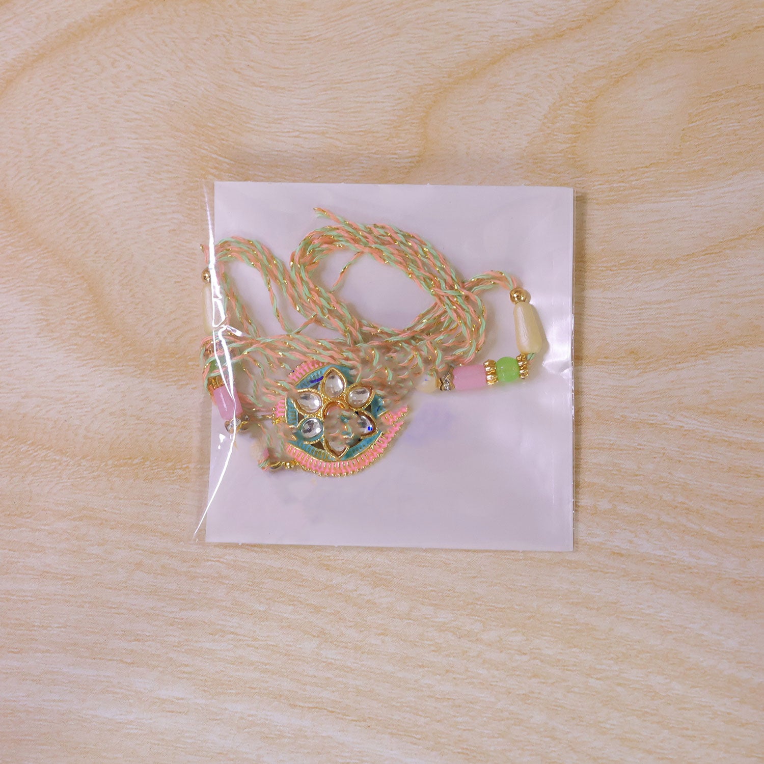 Teal and Pink Round Kundan Pendant Rakhi with Pastel Beads