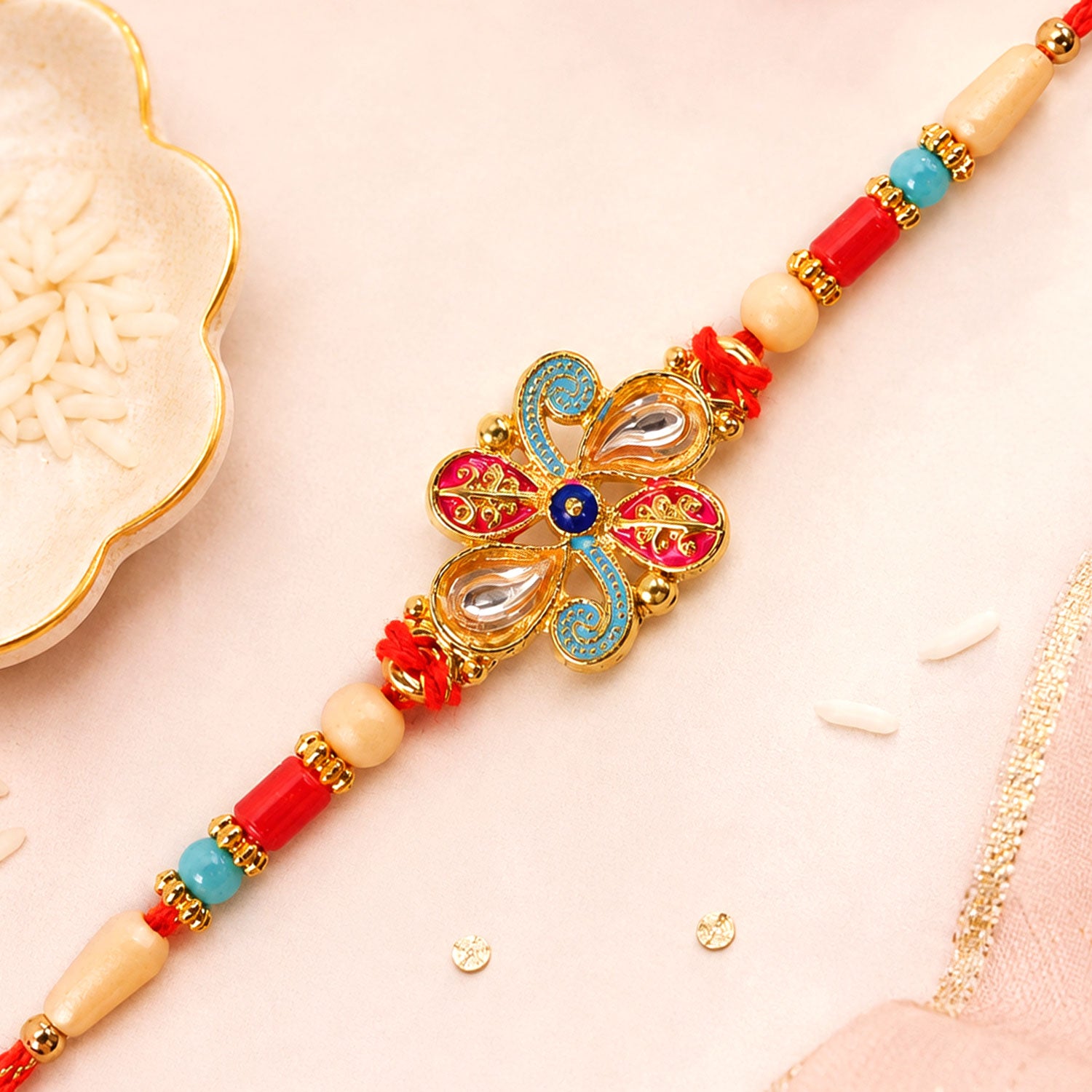Jewel Floral Rakhi with Red Blue Beads and Bright Traditional Celebration Styling