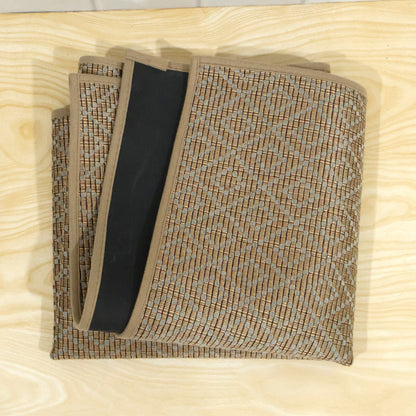 The brown diamond-patterned runner mat is folded neatly, revealing its black backing and woven texture.