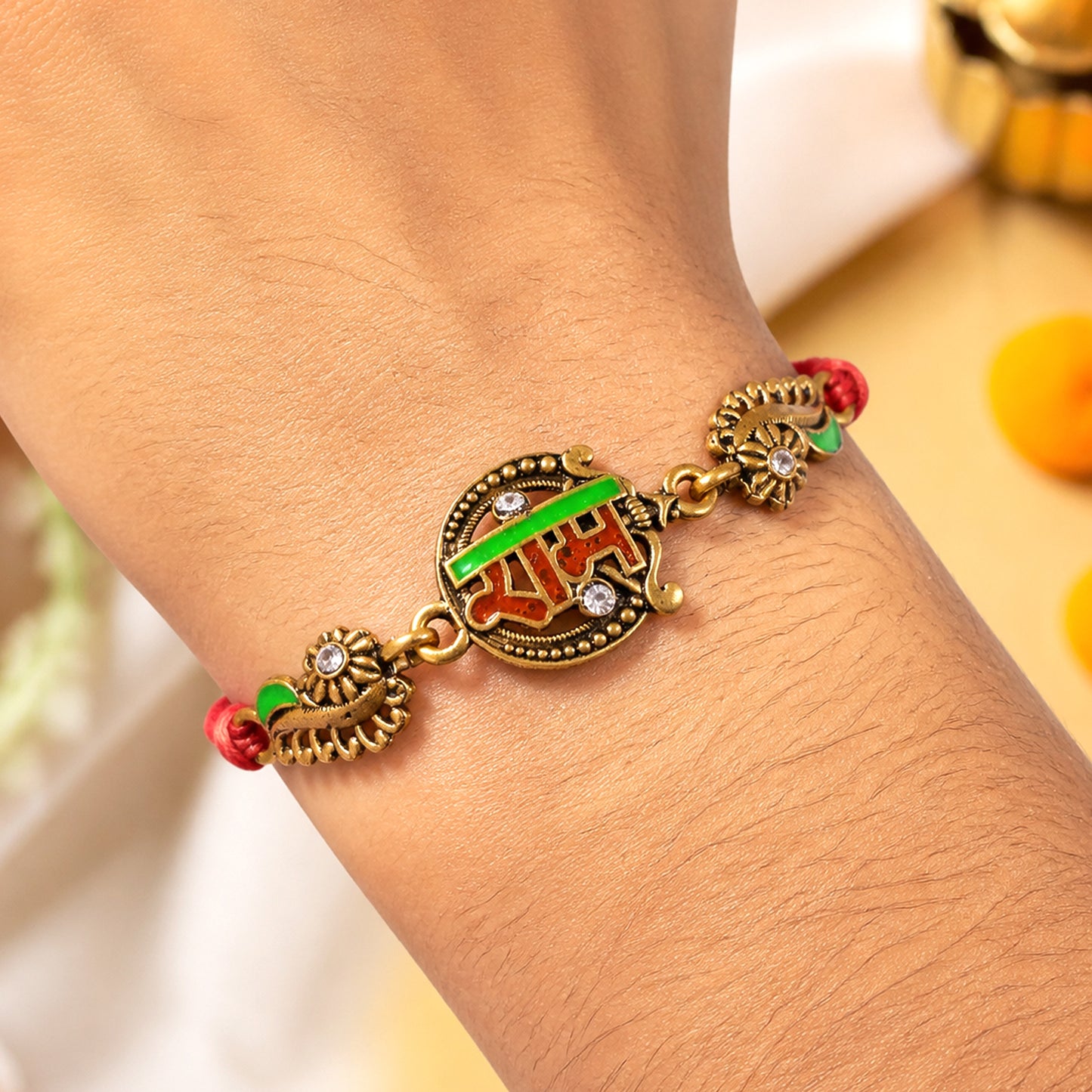 Antique Gold-Toned Ram Rakhi with Crystal Accents, Green Enamel & Designer Red Thread